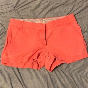 J. Crew bright orange shorts.